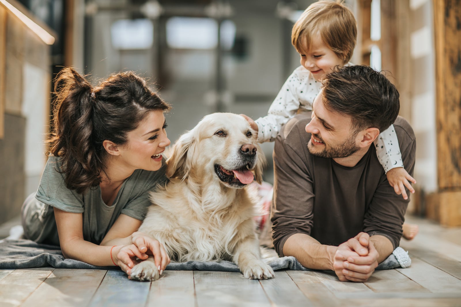 Família feliz com cachorro dentro de casa